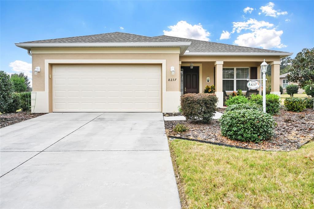 8237 Southwest 78th Terrace Road Ocala, FL 34476 - Photo 1 of 22 a front view of a house with garden