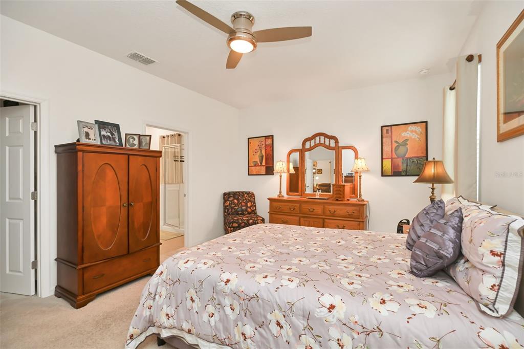 8237 Southwest 78th Terrace Road Ocala, FL 34476 - Photo 11 of 22 a bedroom with a large bed and a dresser