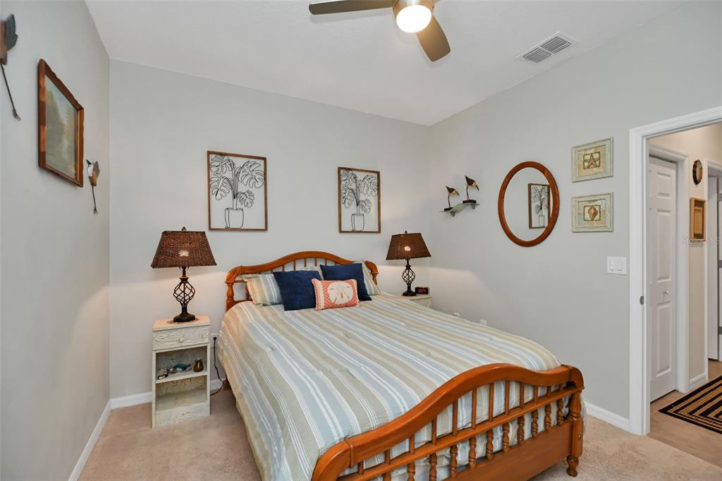 8237 Southwest 78th Terrace Road Ocala, FL 34476 - Photo 16 of 22 a bedroom with bed and a chandelier