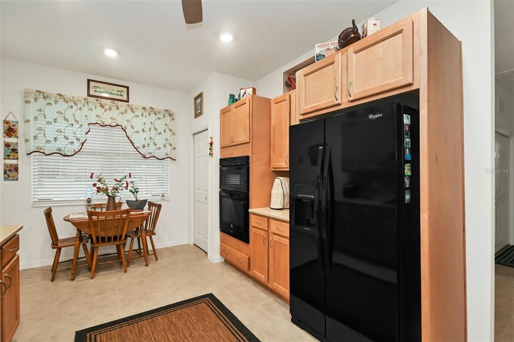 8237 Southwest 78th Terrace Road Ocala, FL 34476 - Photo 8 of 22 a kitchen with stainless steel appliances kitchen island granite countertop a refrigerator and a dining table