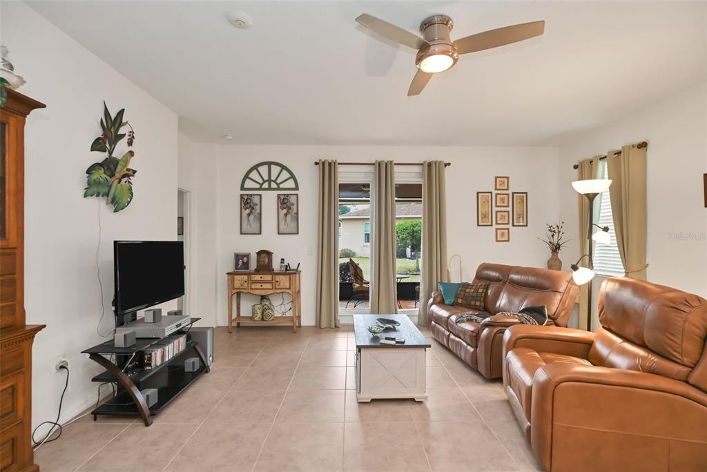 8237 Southwest 78th Terrace Road Ocala, FL 34476 - Photo 9 of 22 a living room with furniture a flat screen tv and a window
