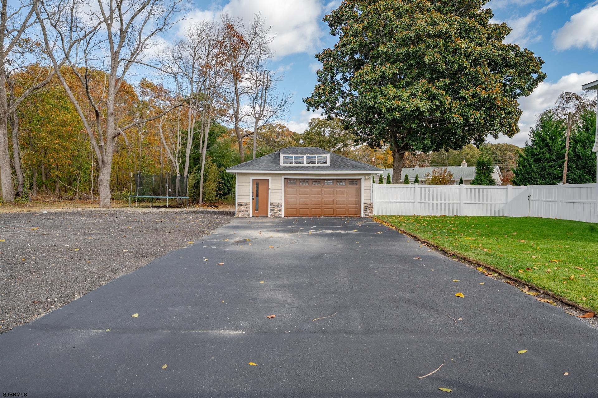 1203 West Mill Road Northfield, NJ 08225 - Photo 49 of 90 a front view of house with yard and trees all around
