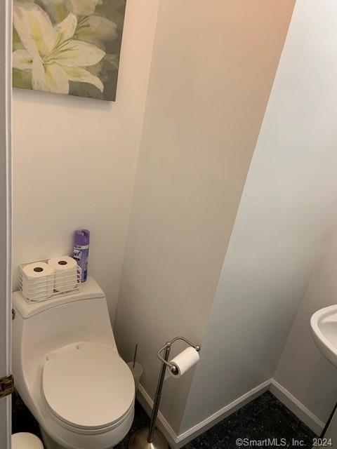 9 Beech Street Farmington, CT 06032 - Photo 10 of 37 a white toilet sitting next to a white sink and vanity