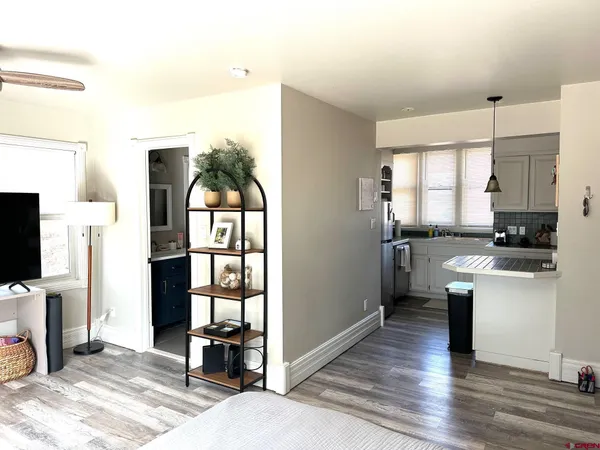 a kitchen with granite countertop a refrigerator stove top oven and sink