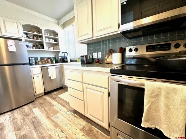 a kitchen with stainless steel appliances granite countertop a stove and a refrigerator