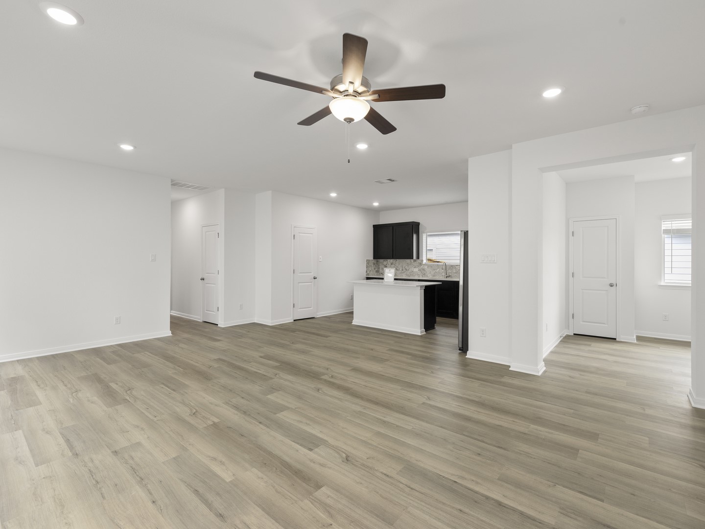 513 Yellow Ribbon Trail Jarrell, TX 76537 - Photo 22 of 23 An open floorplan living area flows seamlessly into a modern kitchen, creating an inviting entertainment space.