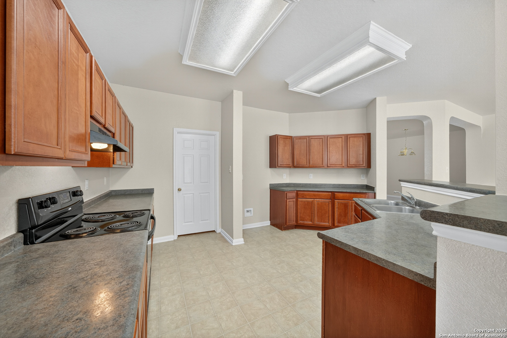 221 Springtree Cove Cibolo, TX 78108 - Photo 11 of 33 a kitchen with stainless steel appliances granite countertop a stove and a sink