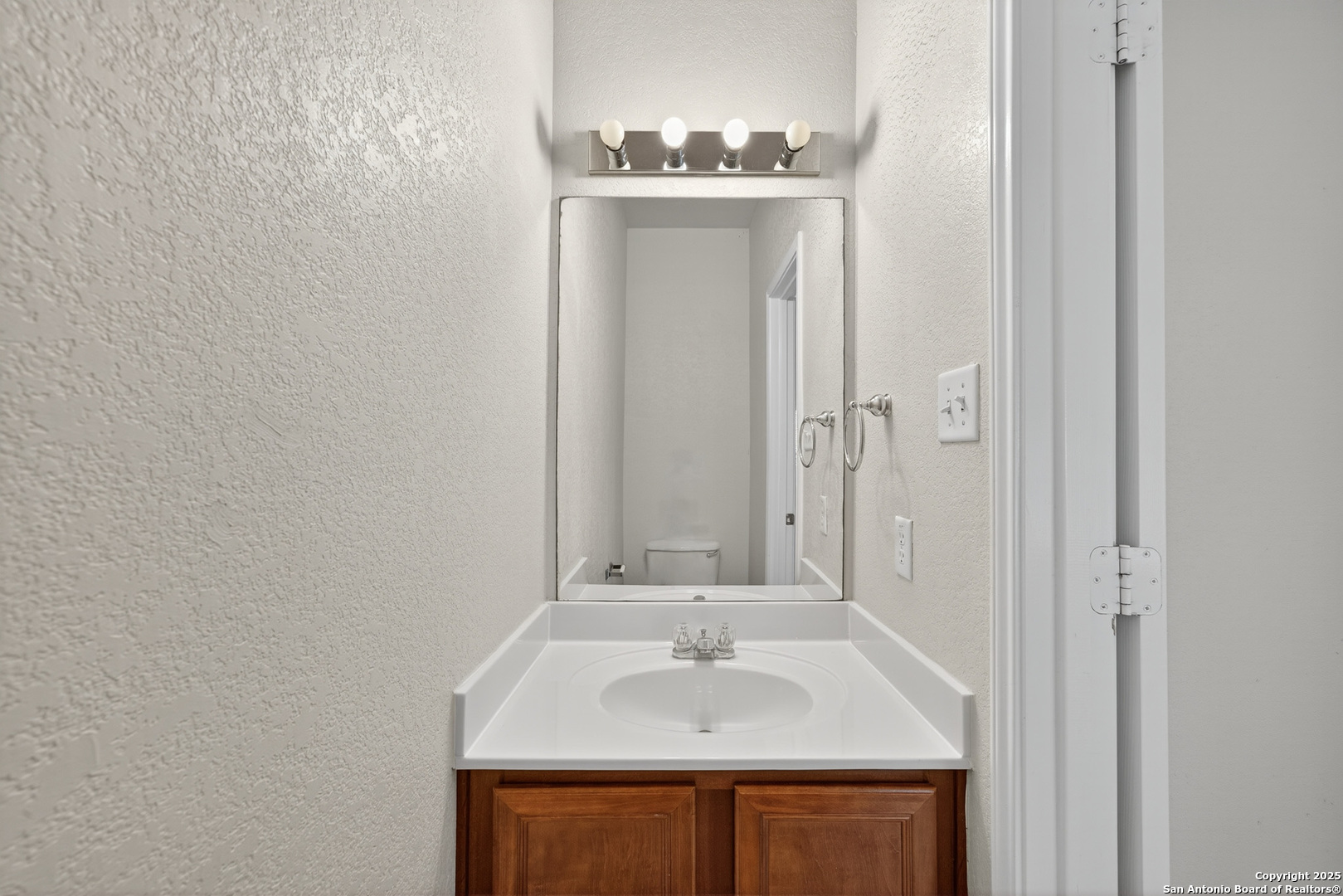 221 Springtree Cove Cibolo, TX 78108 - Photo 17 of 33 a bathroom with a sink and a mirror
