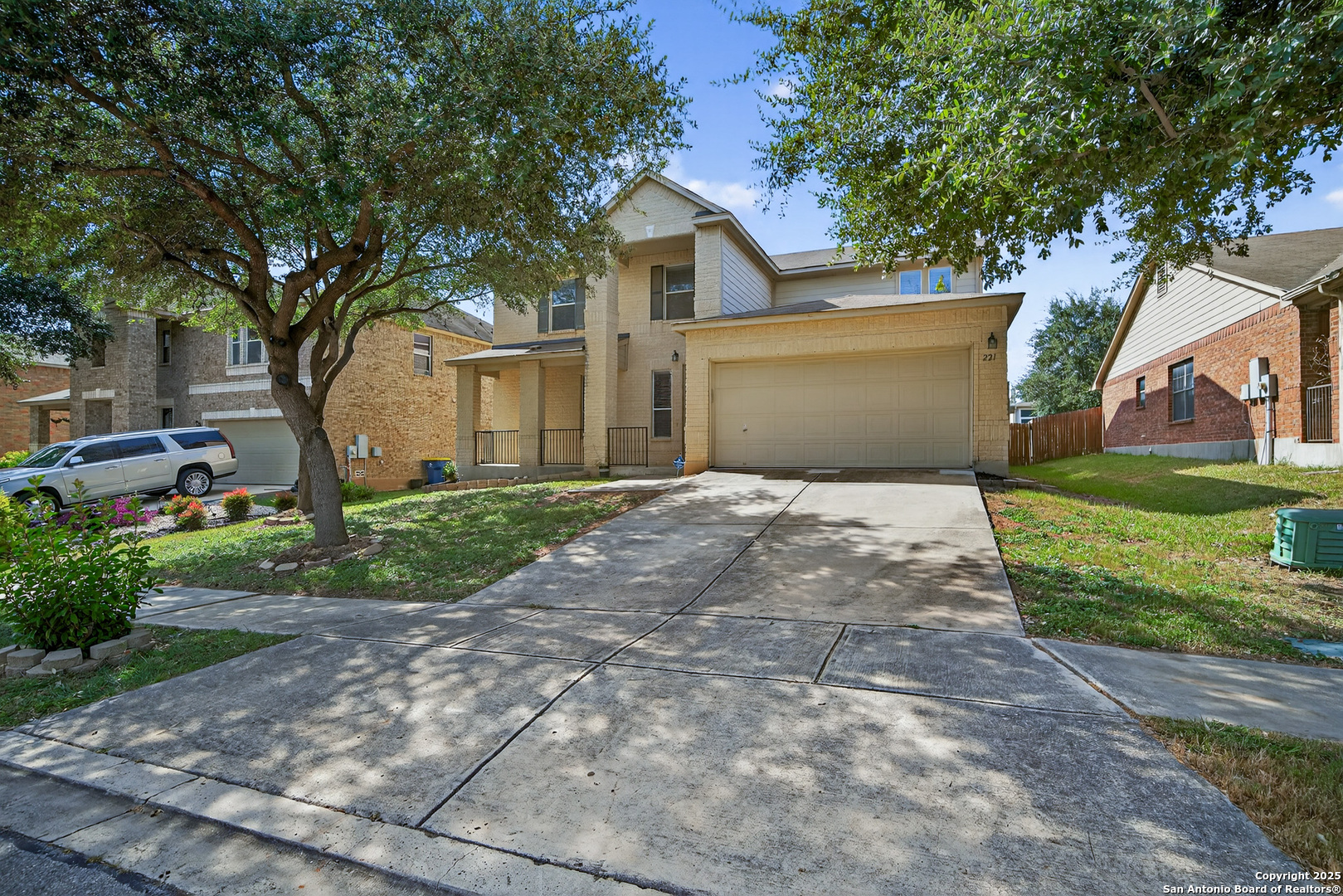 221 Springtree Cove Cibolo, TX 78108 - Photo 2 of 33 a front view of a house with a yard and garage