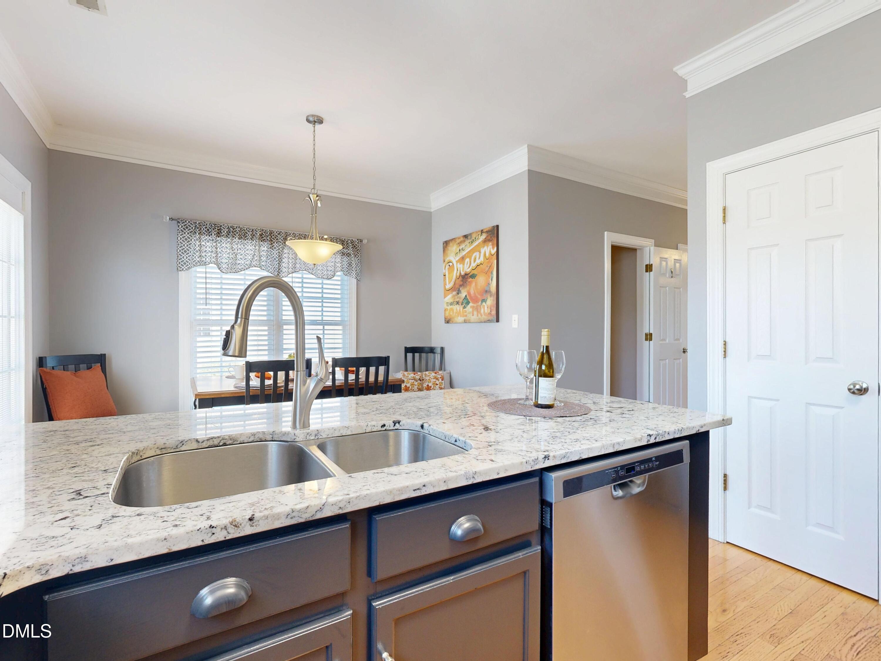 200 Madison Grove Place Cary, NC 27519 - Photo 14 of 49 a kitchen with a granite countertop kitchen island a sink stainless steel appliances and cabinets