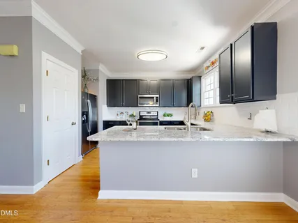 a kitchen with stainless steel appliances granite countertop a refrigerator and a microwave