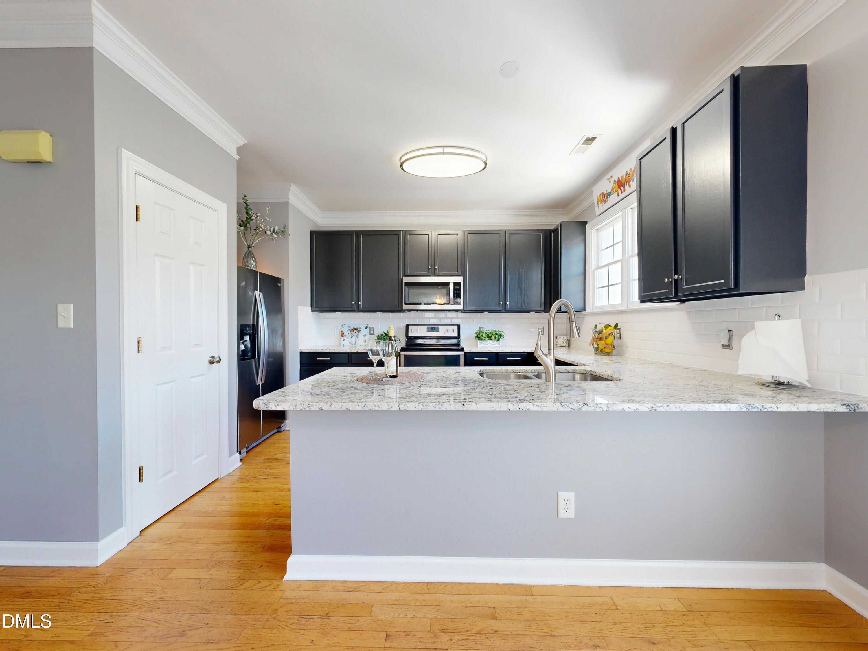 200 Madison Grove Place Cary, NC 27519 - Photo 16 of 49 a view of kitchen with stainless steel appliances granite countertop a stove top oven a sink and dishwasher