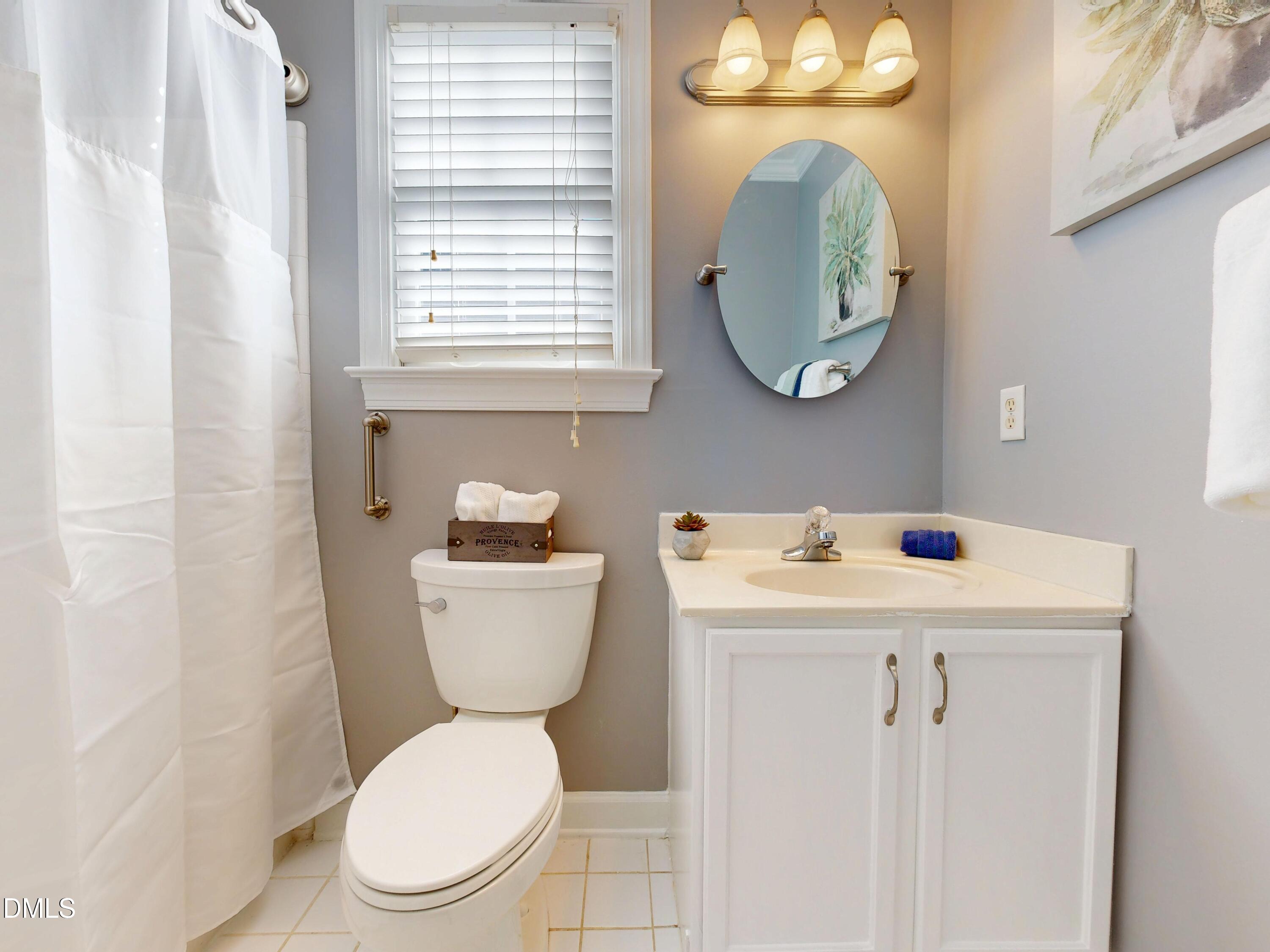 200 Madison Grove Place Cary, NC 27519 - Photo 22 of 49 a bathroom with a toilet sink and mirror