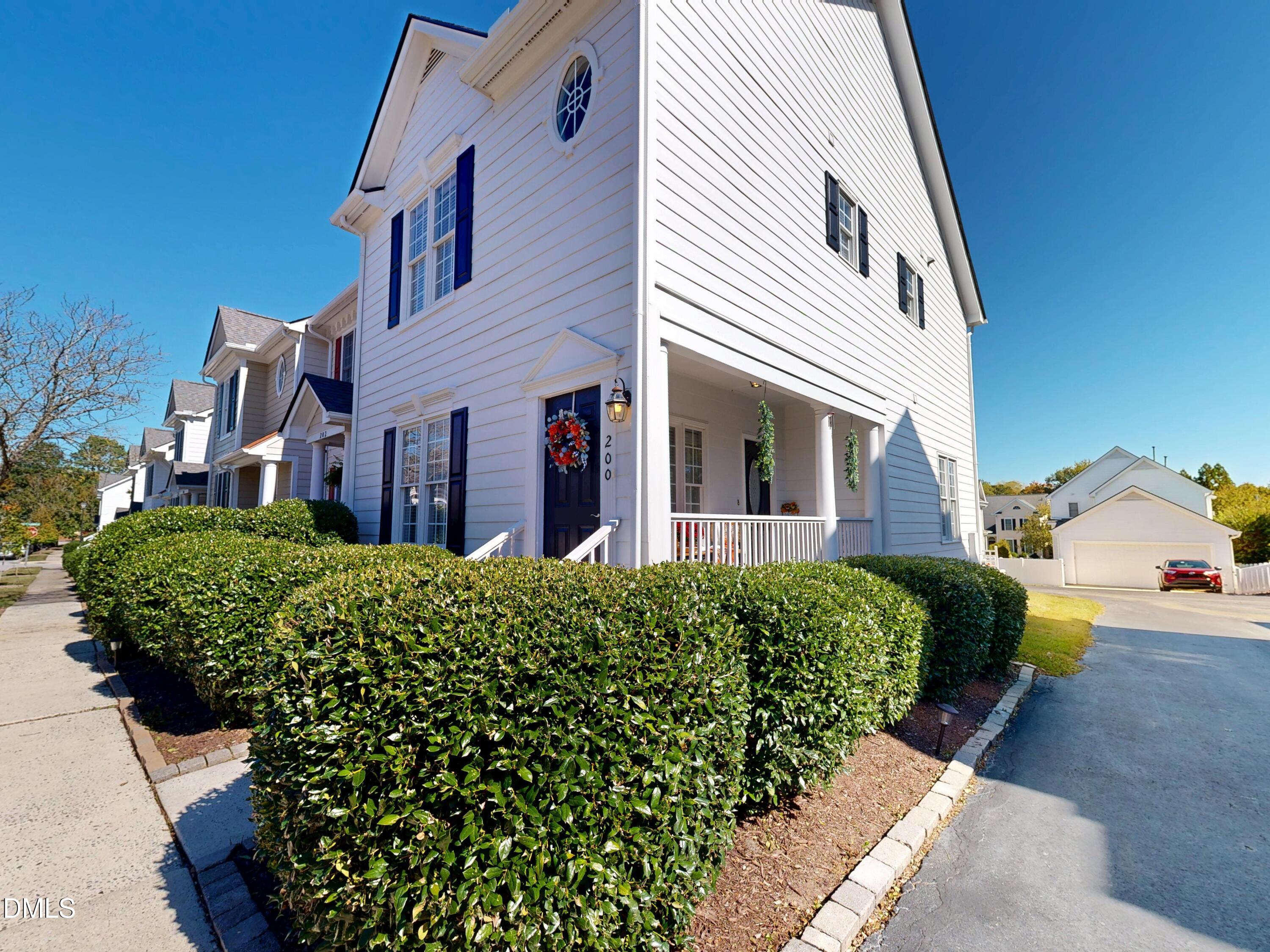 200 Madison Grove Place Cary, NC 27519 - Photo 3 of 49 a front view of a house with a garden