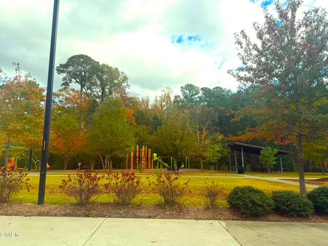 a view of a swimming pool with a lawn chairs under an umbrella