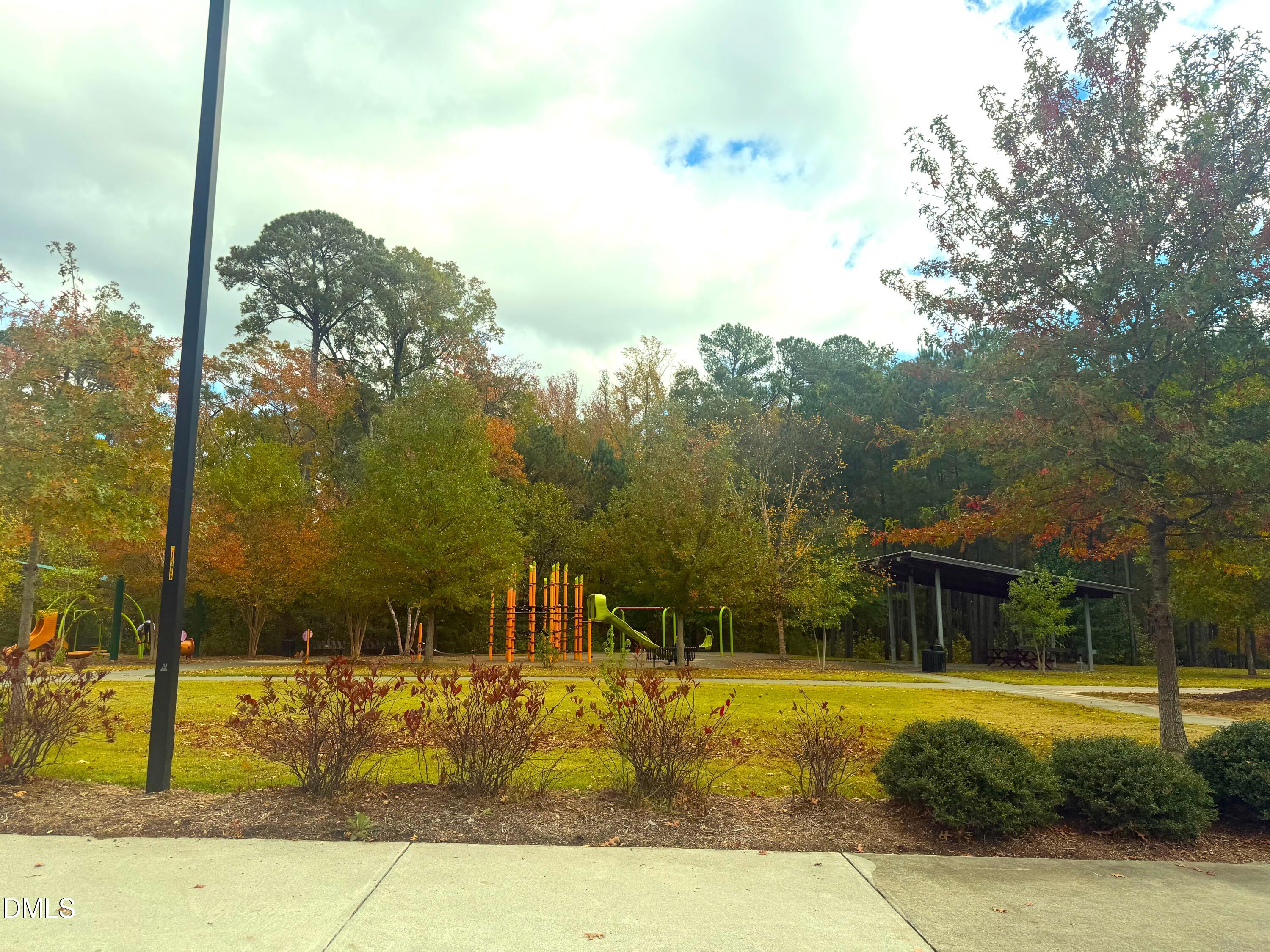 200 Madison Grove Place Cary, NC 27519 - Photo 41 of 49 a view of a swimming pool with a lawn chairs under an umbrella