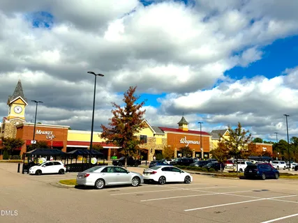 a view of a cars park in front of a building