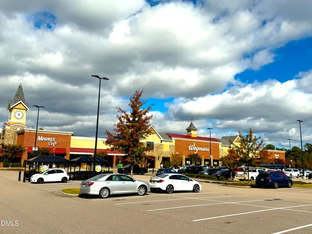 a view of a cars park in front of a building