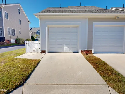 a view of a house with a small yard and deck