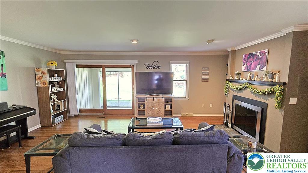 194 Springhouse Road Allentown, PA 18104 - Photo 4 of 34 This inviting living space features gleaming hardwood floors and a cozy fireplace, perfect for gatherings.