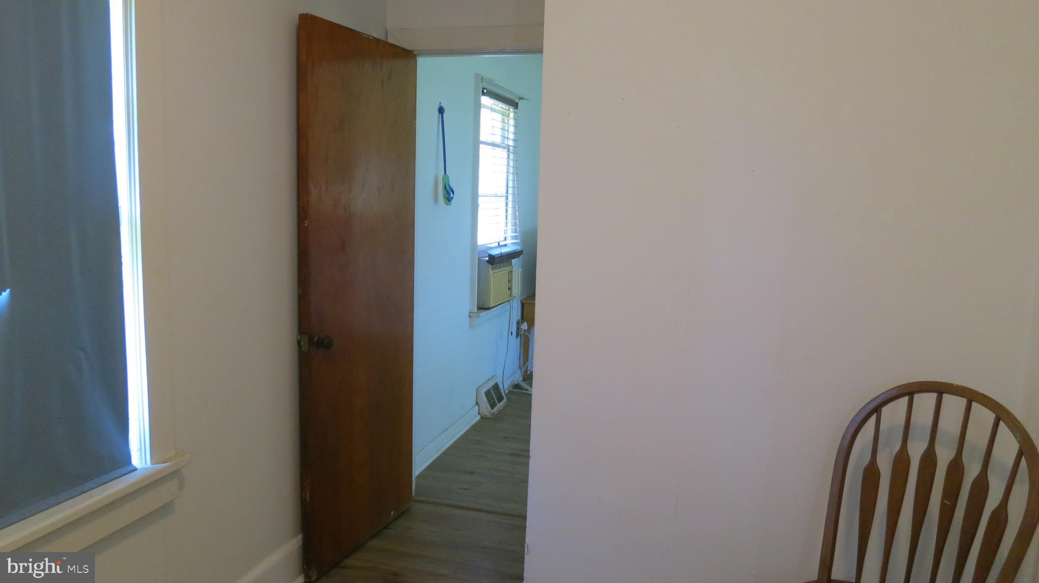 79 Ewingville Road Ewing, NJ 08638 - Photo 59 of 67 a view of a hallway with wooden floor and a bathroom