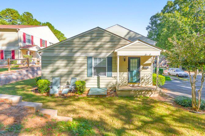 a view of house with backyard