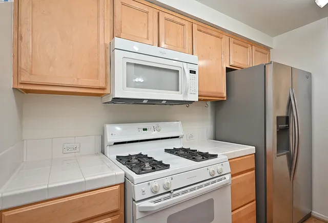 a kitchen with a stove and a microwave