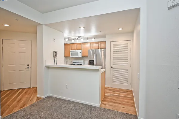 a kitchen with stainless steel appliances a refrigerator sink and stove