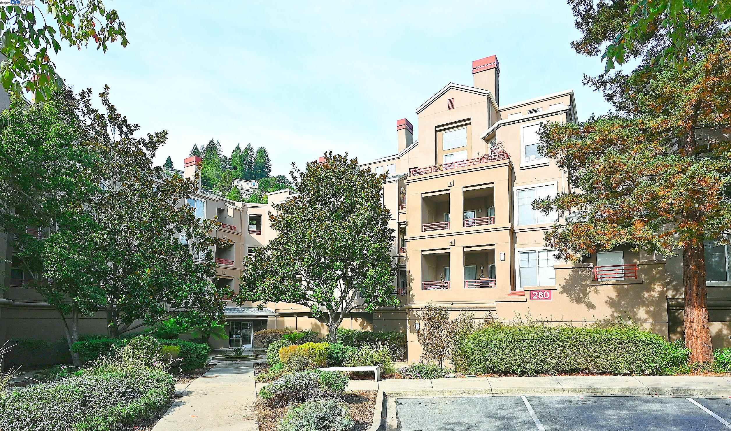 280 Caldecott Lane, Unit 221 Oakland, CA 94618 - Photo 30 of 31 a front view of a house with a yard