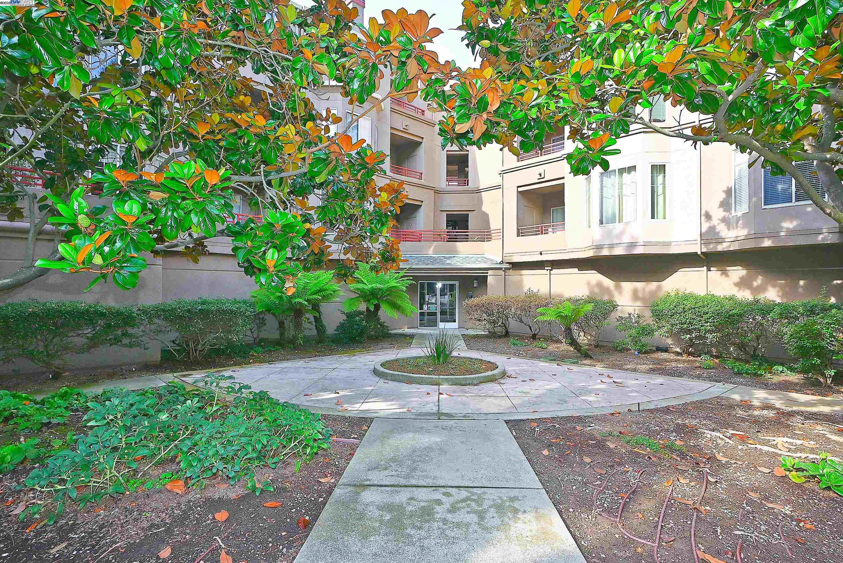 280 Caldecott Lane, Unit 221 Oakland, CA 94618 - Photo 31 of 31 a front view of a house with a yard and trees