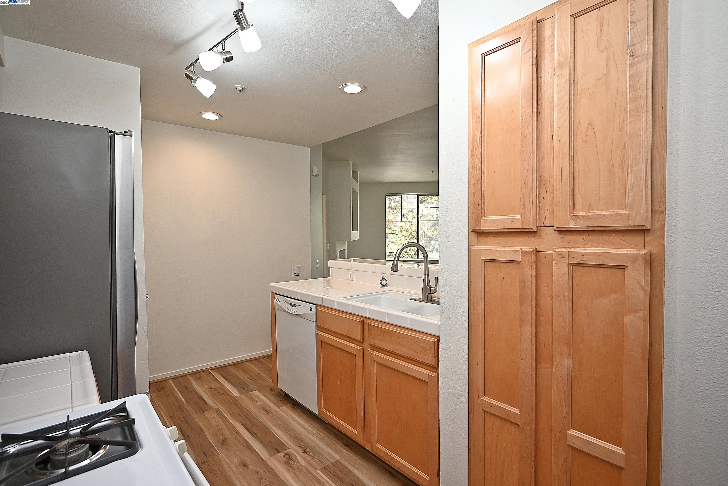 280 Caldecott Lane, Unit 221 Oakland, CA 94618 - Photo 9 of 31 a bathroom with a sink a mirror and a vanity