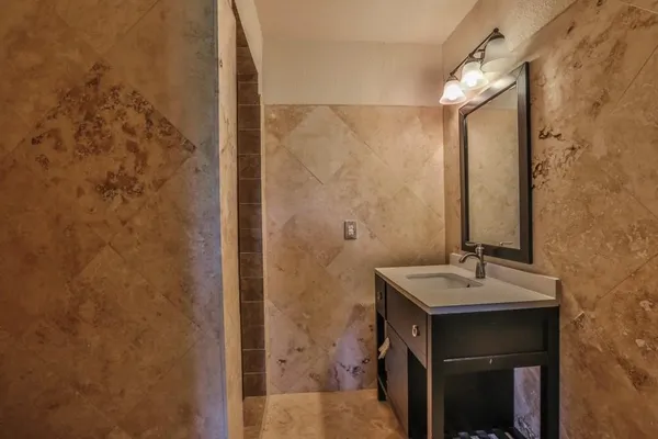 a bathroom with a sink a toilet and a mirror