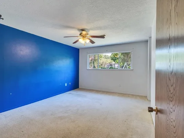 a view of a big room with closet and chandelier fan