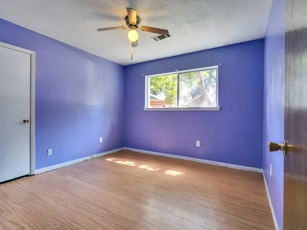 a bathroom with a granite countertop sink a mirror and a shower