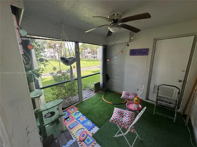 a view of a room that has a bed and a table in it