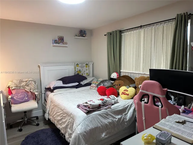 a bedroom with a bed and a desk