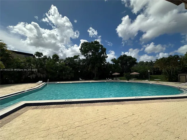 a view of a swimming pool with outdoor seating