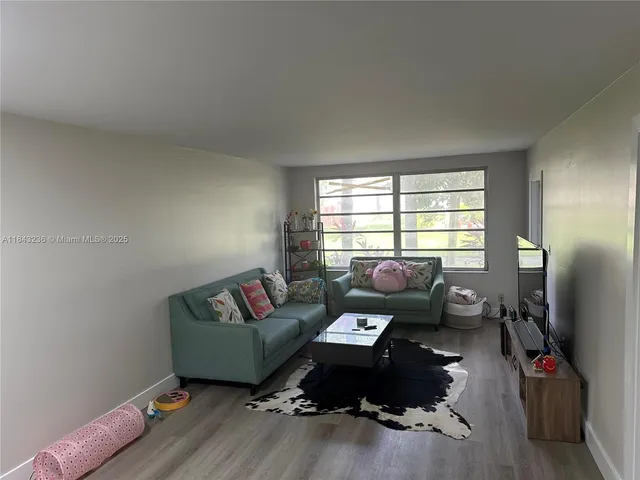 a living room with furniture window and flat screen tv