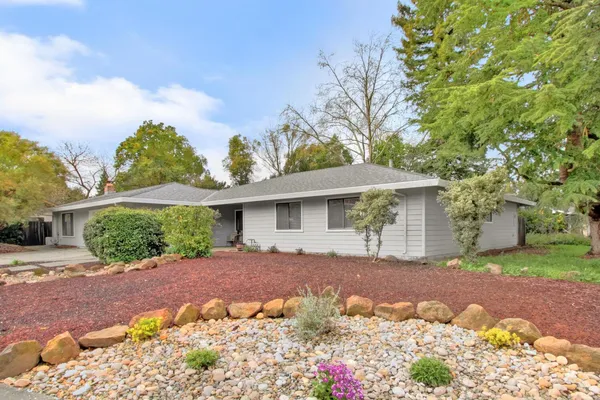 a front view of a house with a yard and a garage