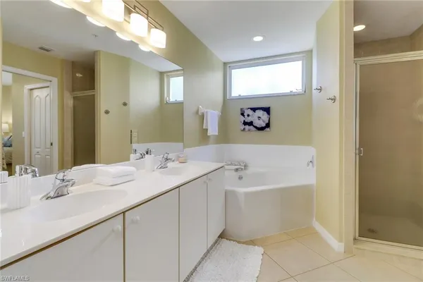 a en suite bathroom with a sink double vanity and a mirror