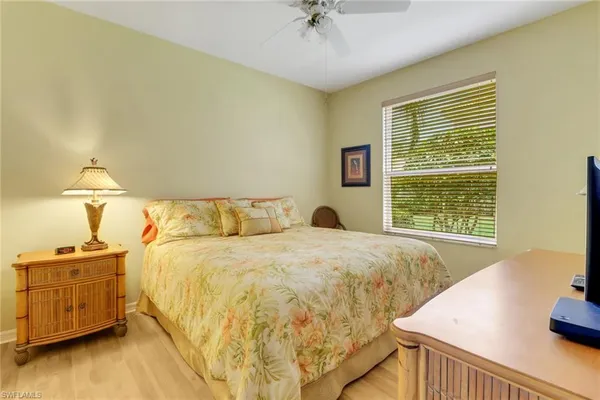 a bed sitting in a bedroom next to a window