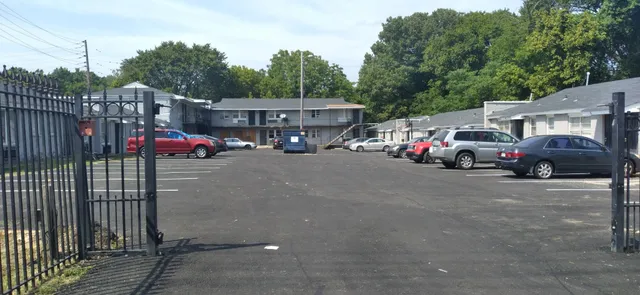 a view of an empty room with wooden floor and closet