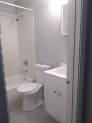a bathroom with a window and a yard