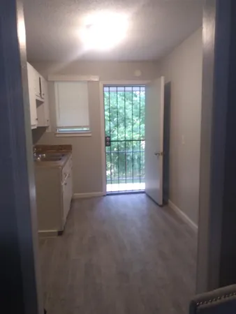 a view of a balcony with a glass door