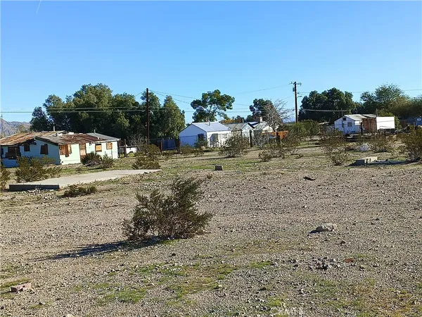 a view of a house with a yard covered in snow