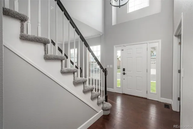 a view of entryway and hall with wooden floor