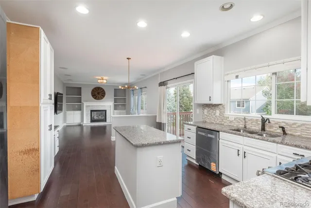 a kitchen with stainless steel appliances granite countertop sink stove top oven and cabinets