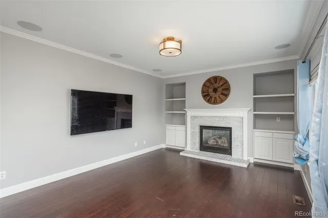 a view of an empty room with a fireplace and a window