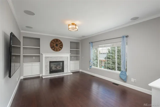 a living room with a fireplace and a floor to ceiling window