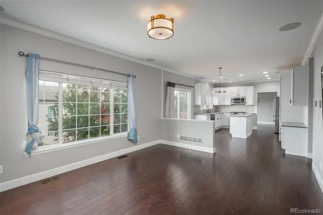 a view of kitchen with furniture and wooden floor